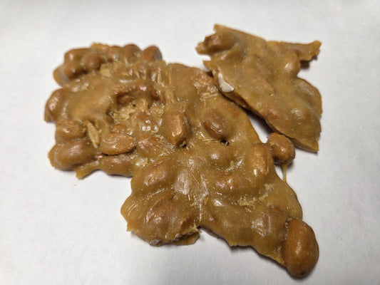 Clumps of peanut brittle on a white surface